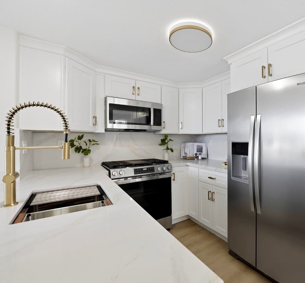 Finished white kitchen remodel with brass fixtures in Del Mar by MA Properties